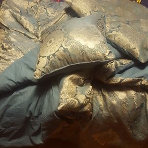 A queen comforter with ome throw pillow and sham